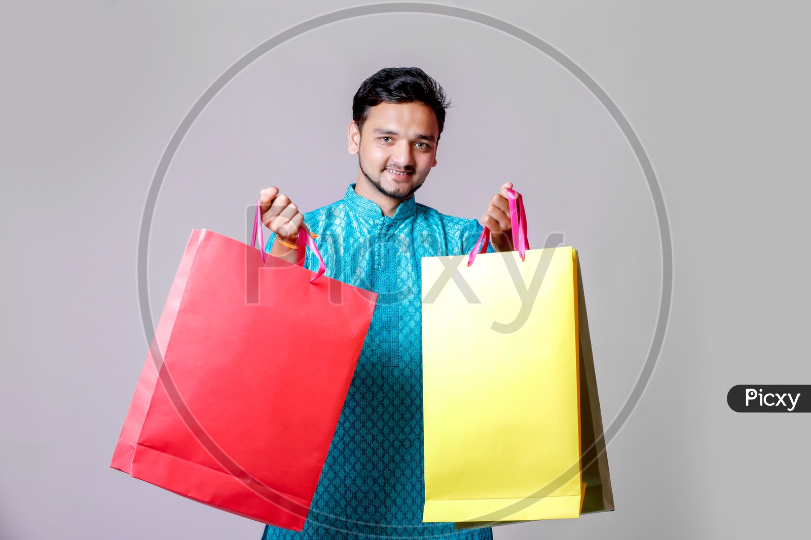 Portrait of a happy Indian Men carrying shopping bags with white background