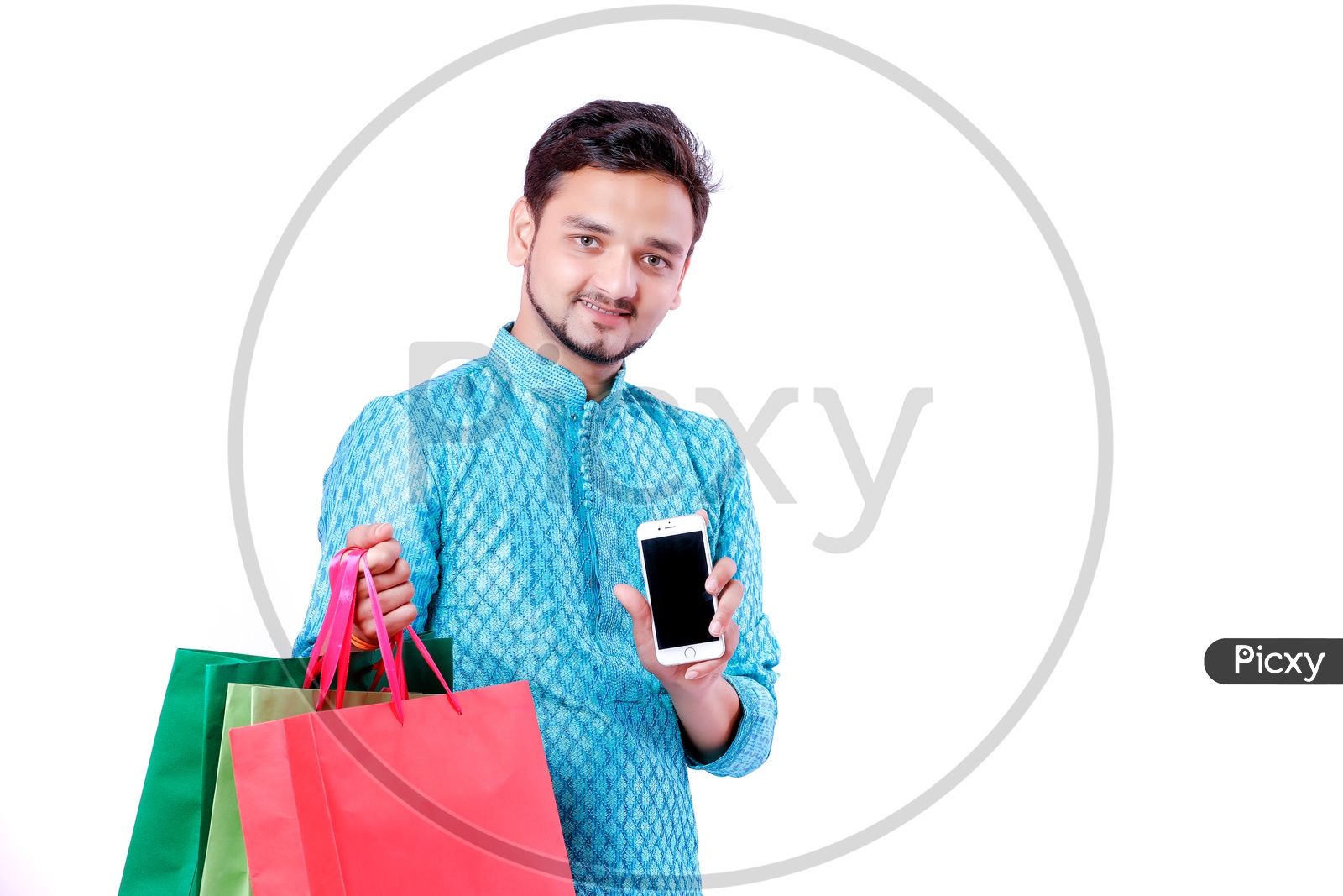 Portrait of a happy Indian Men carrying shopping bags and mobile in hand with white background