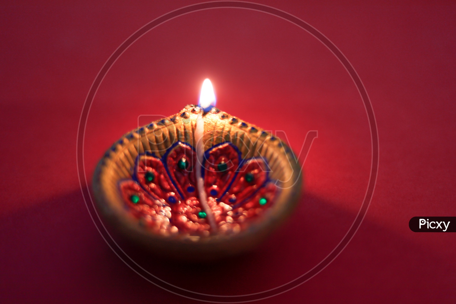 Diwali diya or lamp on red color background