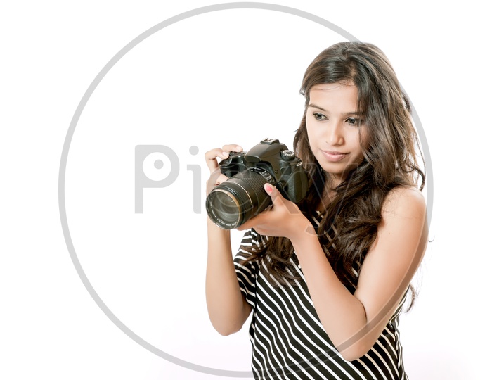 Indian girl  photo with digital camera/ DSLR holding in hands  on white background