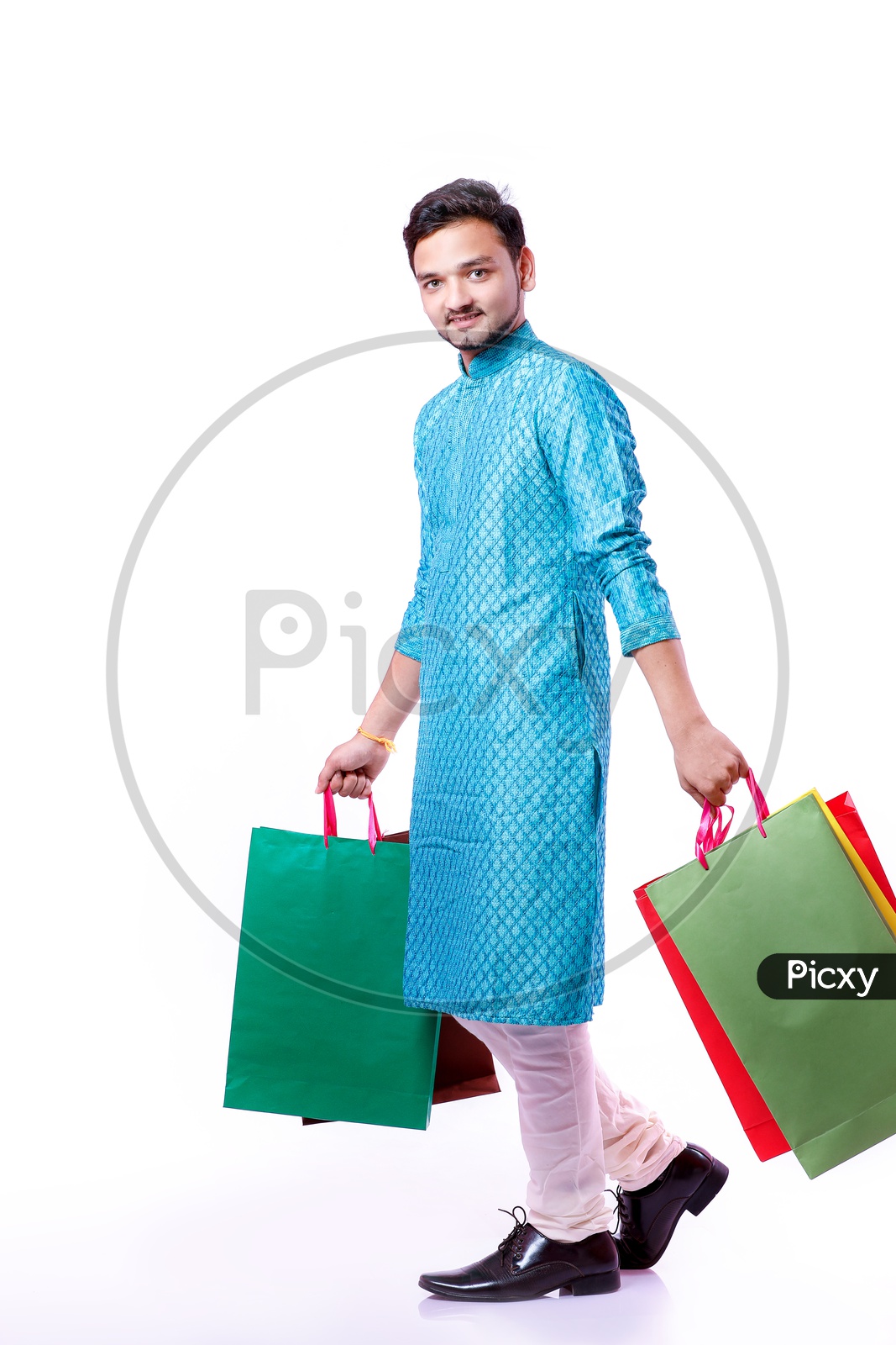 Portrait of a happy Indian Men carrying shopping bags  with white background