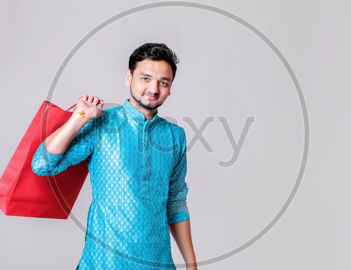 Portrait of a happy Indian Men carrying shopping bags with white background