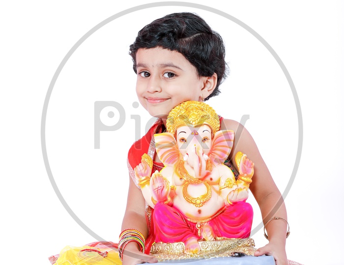 Indian Girl Child  With Lord Ganesh Statue On an Isolated White Background