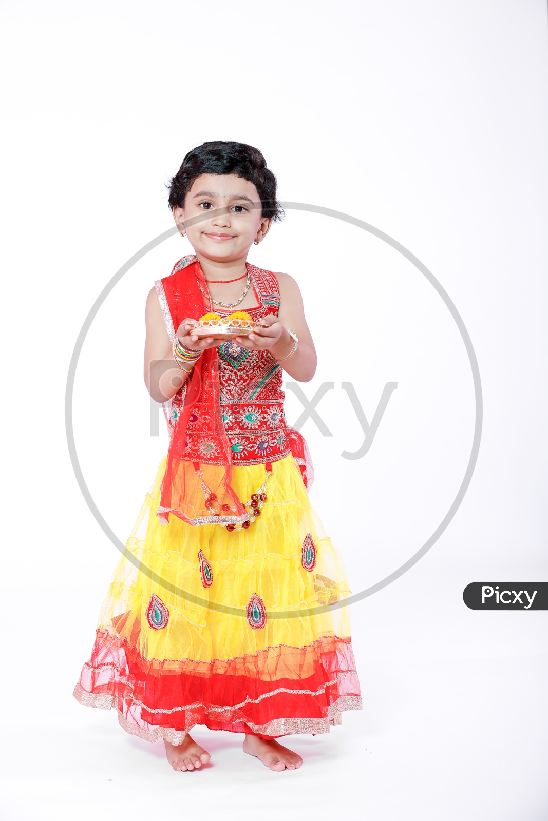 Indian Girl Child  With Puja Basket on a Isolated White Background with a Smiling Face
