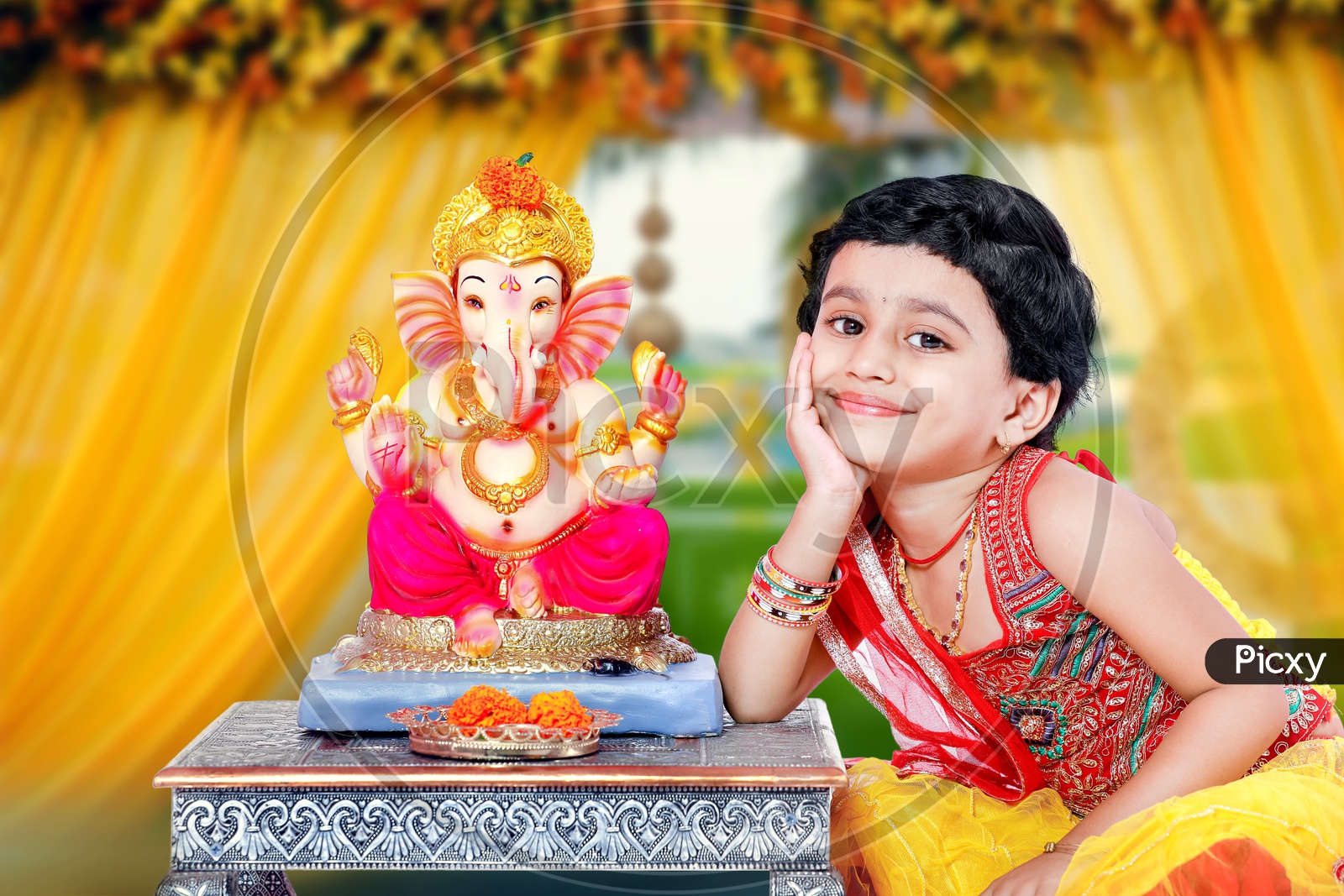Indian Girl Child With Lord Ganesh Statue