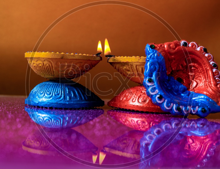 Diwali Indian Festival Diya or lamp with yellow background / Lightened Up Diya / Diwali Festival of India