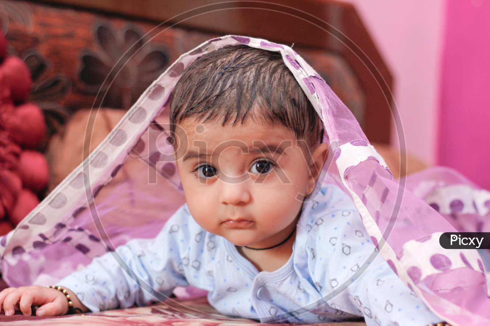 Indian Cute Baby Boy Lying On Bed With A Cute Expression On Face Closeup shot