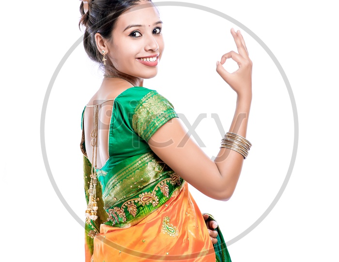 Indian Young Lady Wearing Saree And Showing Gestures With a Smiling Face on an Isolated White Background