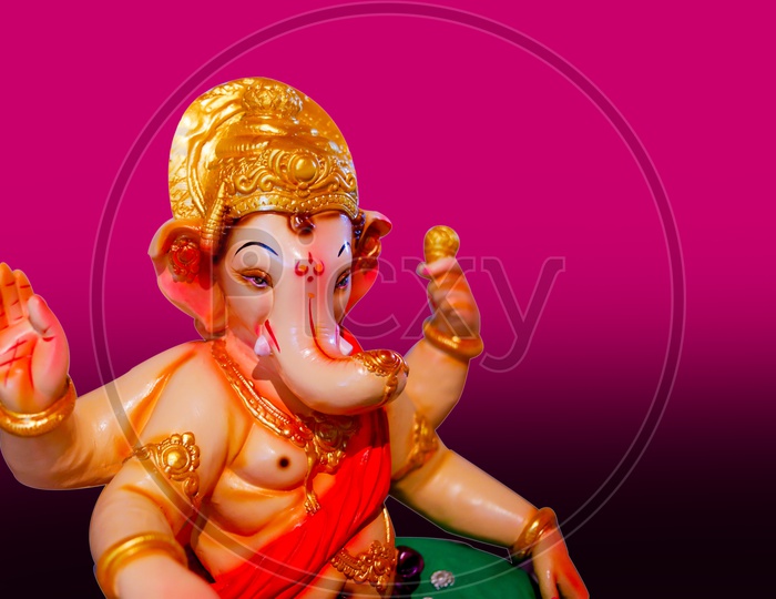 Close up shot of Lord Ganesh Idol with Pink Background