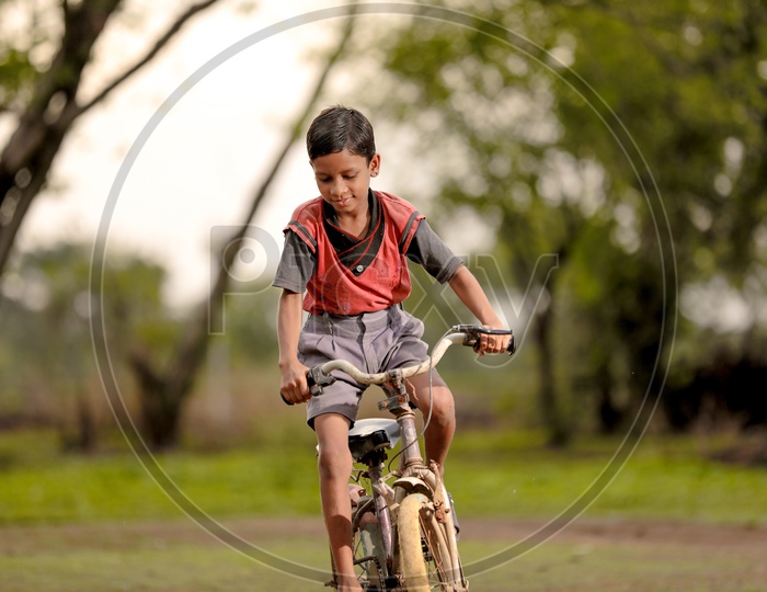 Indian Boy Child Riding Bicycle in Rural India