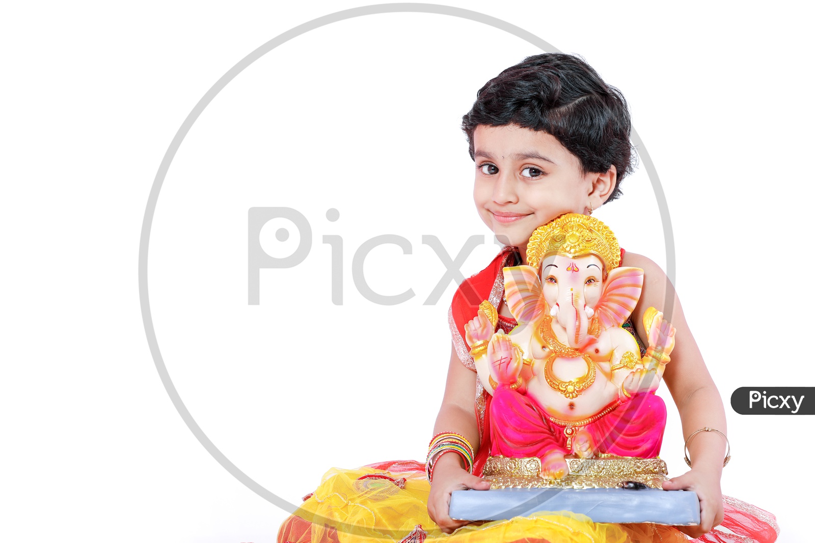 Indian Girl Child  With Lord Ganesh Statue On an Isolated White Background