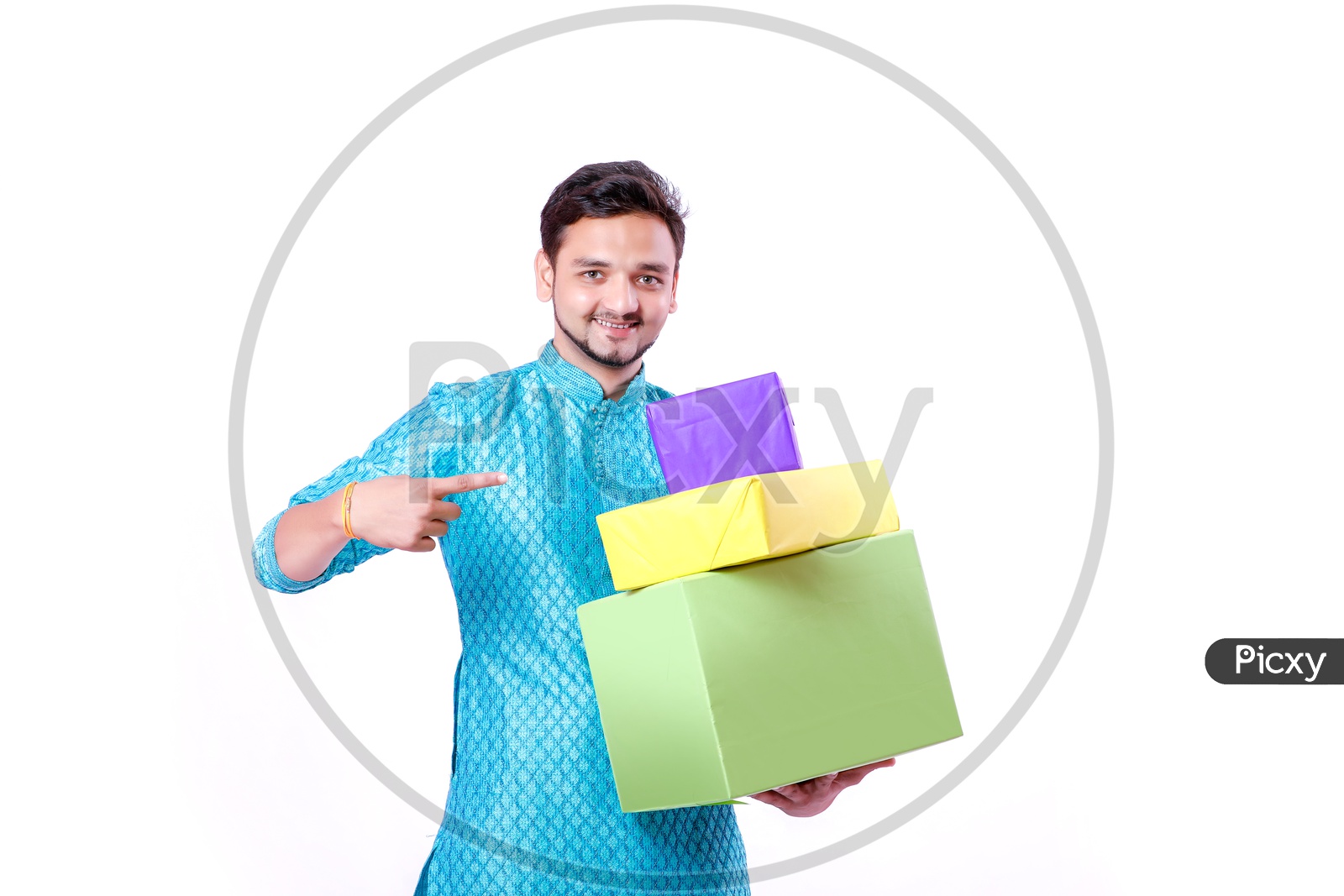 Portrait of a happy Indian Men pointing towards  gifts in hands  with white background