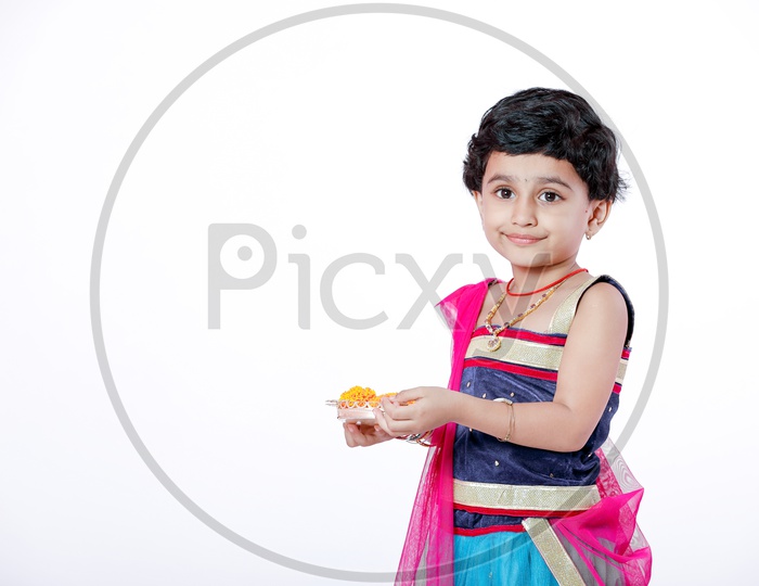 Indian Girl Child  With Puja Basket on a Isolated White Background with a Smiling Face