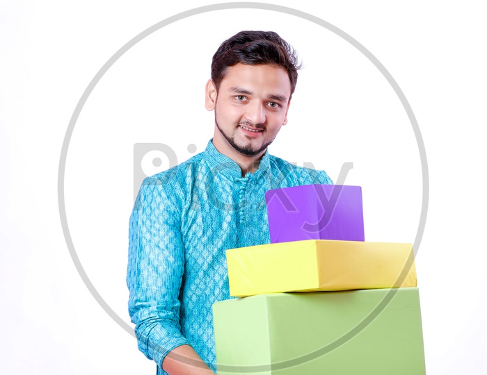 Portrait of a happy Indian Men carrying gifts in hands  with white background