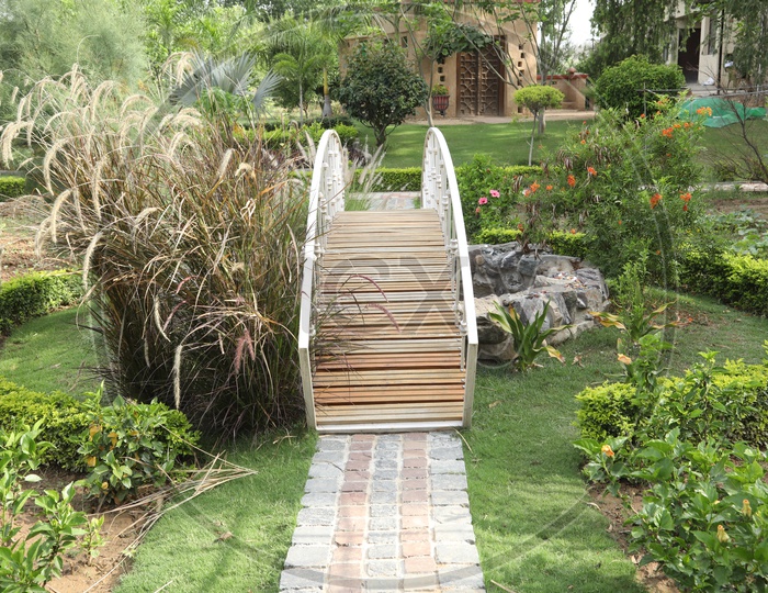 A Small Wooden Bridge in a Lawn Garden
