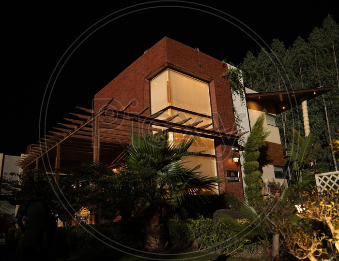 An individual Villa With Plants In Night Time