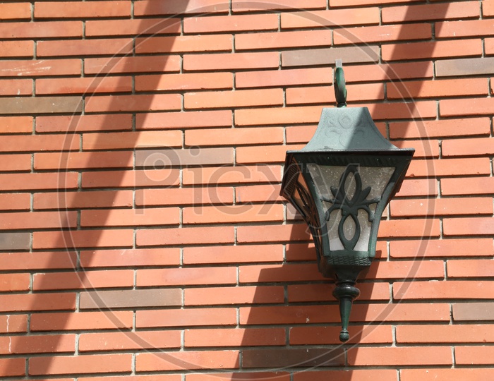A lamp Post Hanging To a Wall