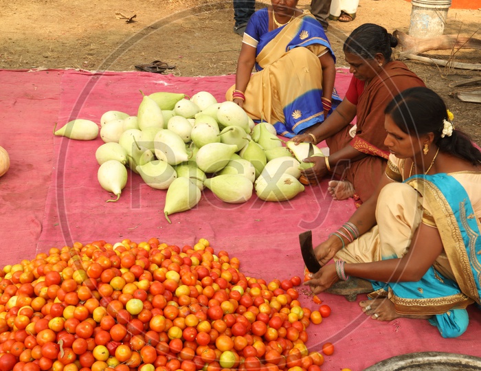 Indian women's cutting vegetables