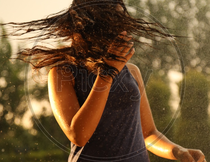 Young Girl Swirling her wet Hair