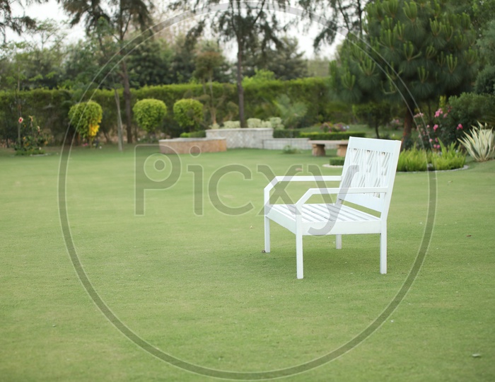 photograph of white chair in garden