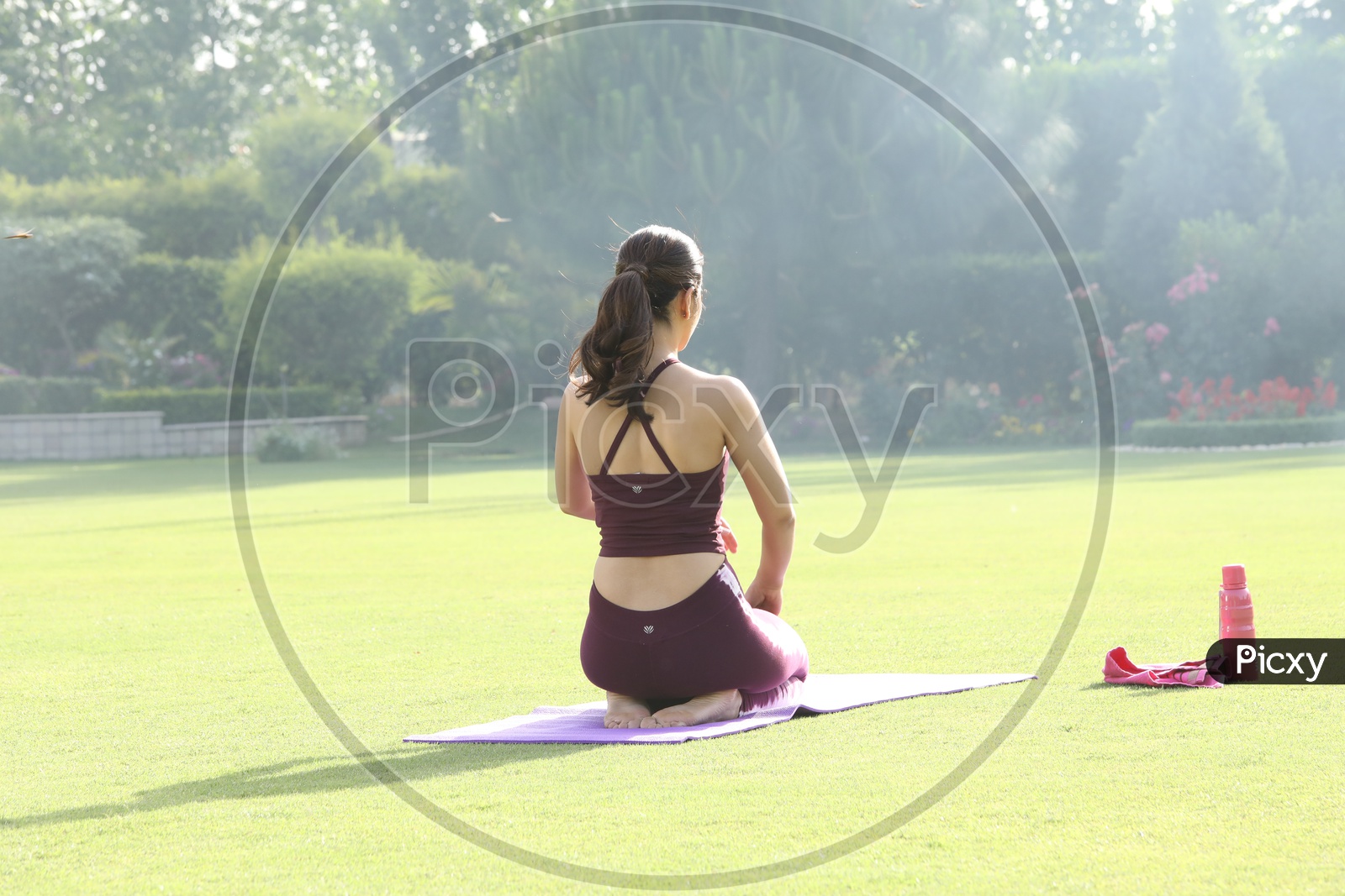 indian girl doing yoga in garden