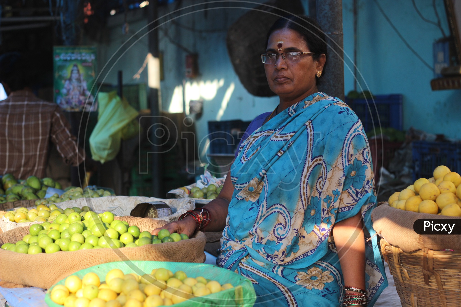Woman seller at Vegetables Market - Lemons and Gooseberries