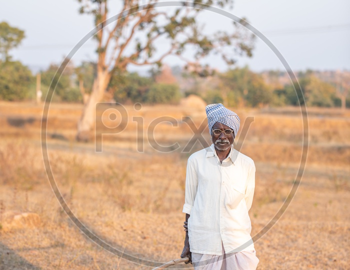 An Indian Old Man In Villages Of Telangana With Agricultural Tool in Hand