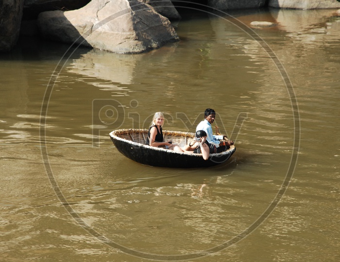 Foreigners Sailing On an Indian Coracle
