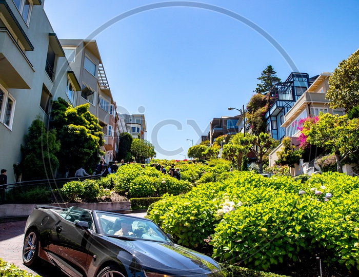 A Car Parked on a Road Side Of a Hill Top Villas In San Francisco