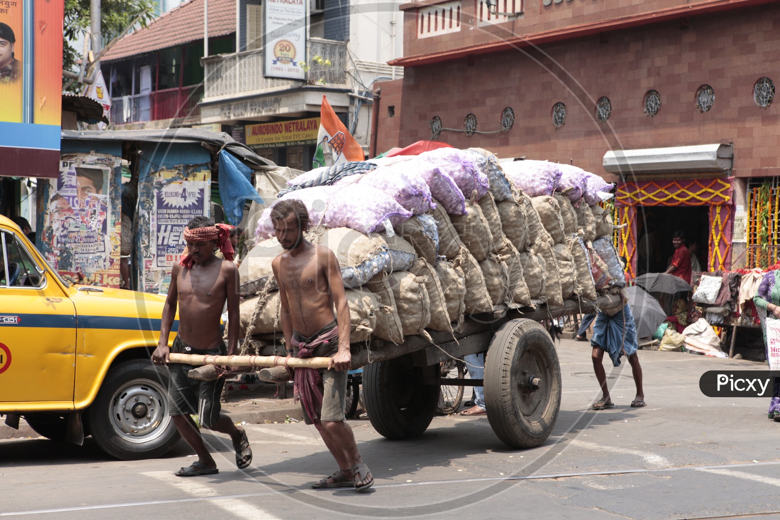 Indian Cart Pullers With Heavy Weights on Cart