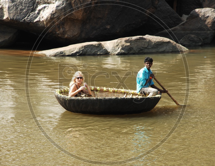 Foreigners Sailing on  Indian Coracle