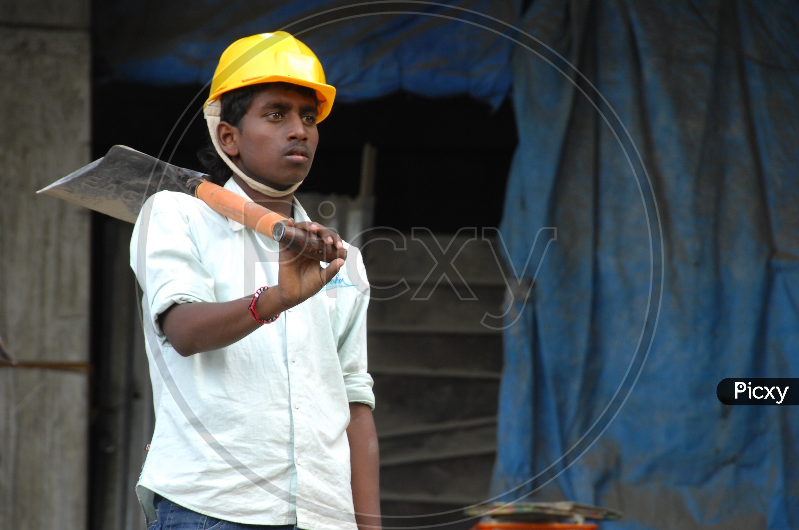 Indian Daily Workers on a Construction Site Wearing Yellow Caps For Safety