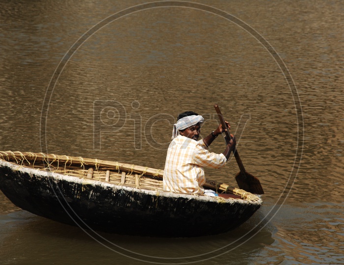 Indian Man Sailing on Coracle