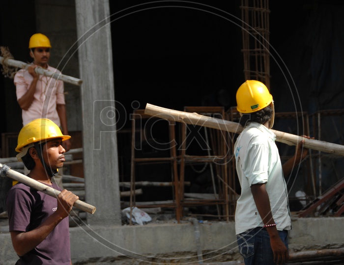 Indian Daily Workers on a Construction Site Wearing Yellow Caps For Safety