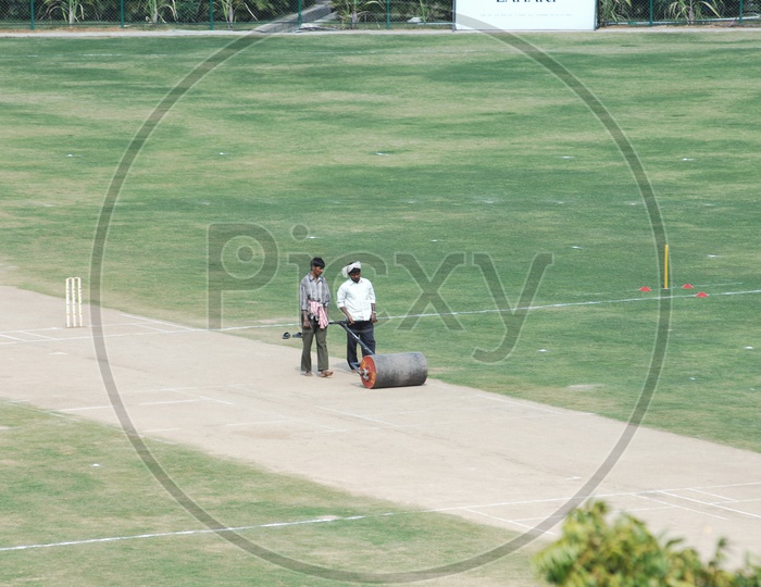 Indian Man  Working On a Cricket Pitch