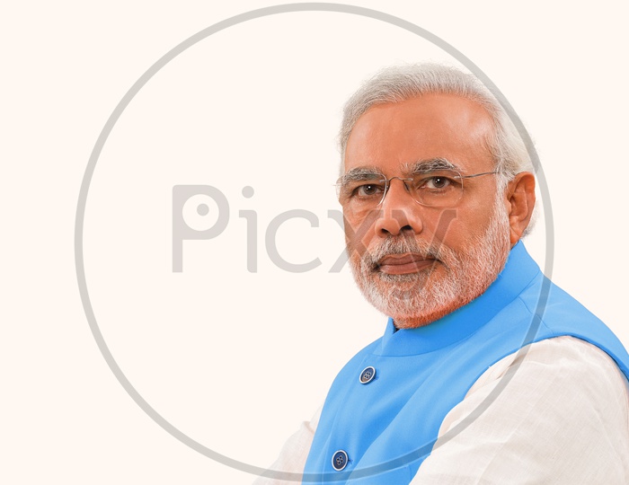 14th Prime Minister of India Narendra Modi who started his journey from chaiwala smiling with white background in blue suit