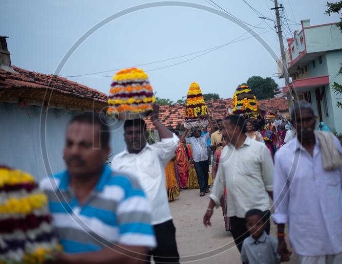 people carry Bathukamma, a floral decoration  on Saddula bathukamma (pedda bathukamma) day in Telangana.