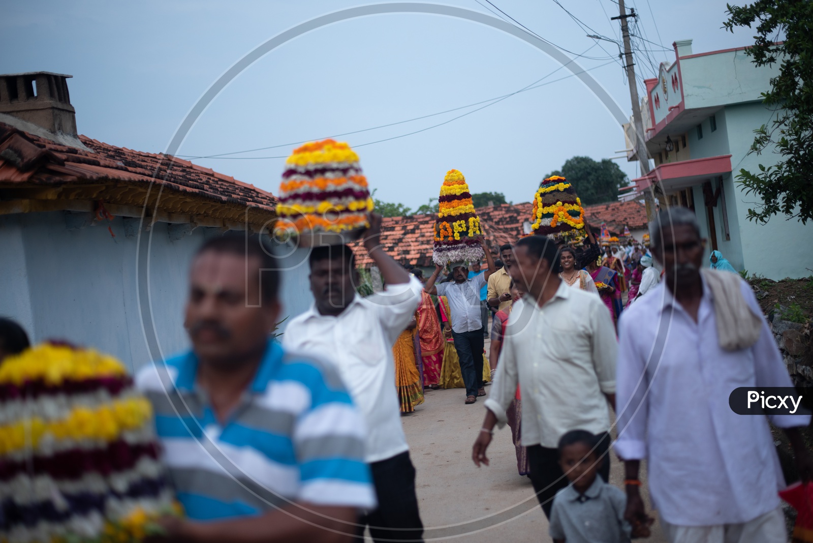 people carry Bathukamma, a floral decoration  on Saddula bathukamma (pedda bathukamma) day in Telangana.