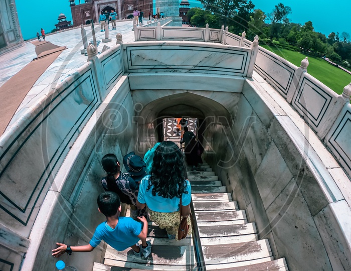 Tourists taking the steps out of the mausoleum