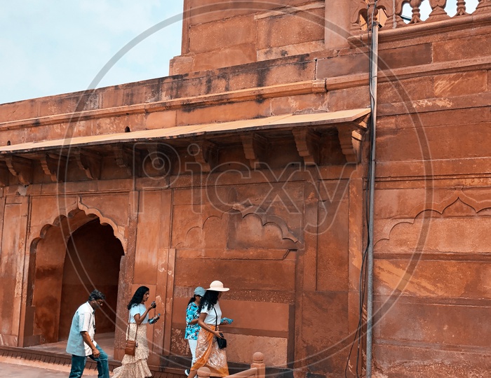 Tourists walking past the Mosque in Taj Mahal