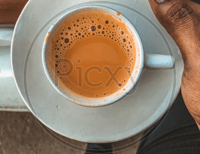 Indian Man holding a cup of Tea