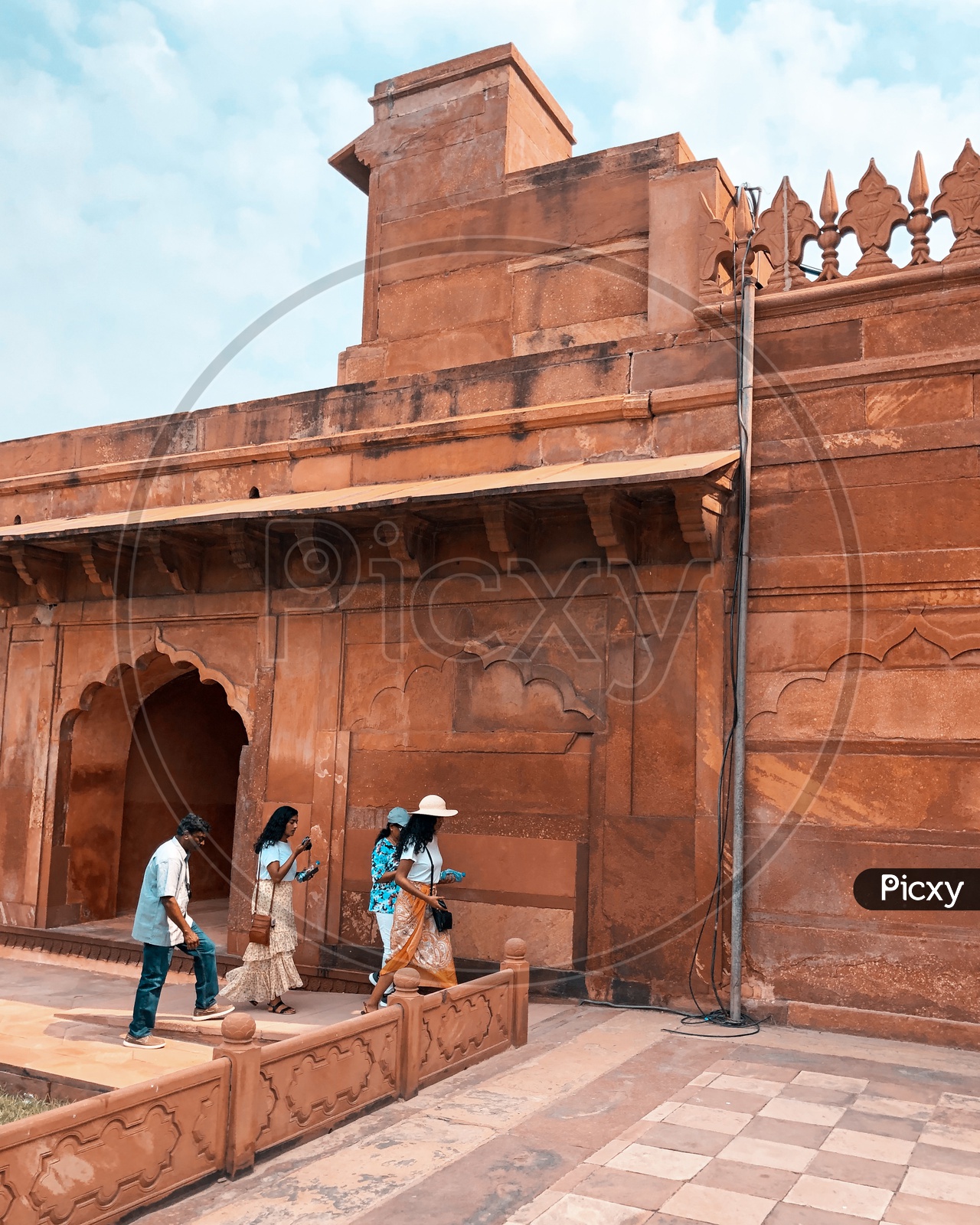 Tourists walking past the Mosque in Taj Mahal