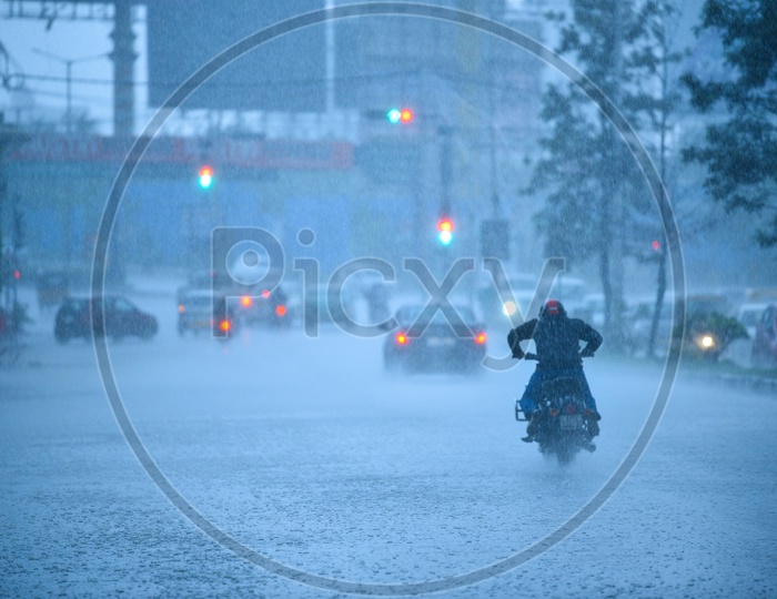 Bike Commuter Riding In Heavy Rain