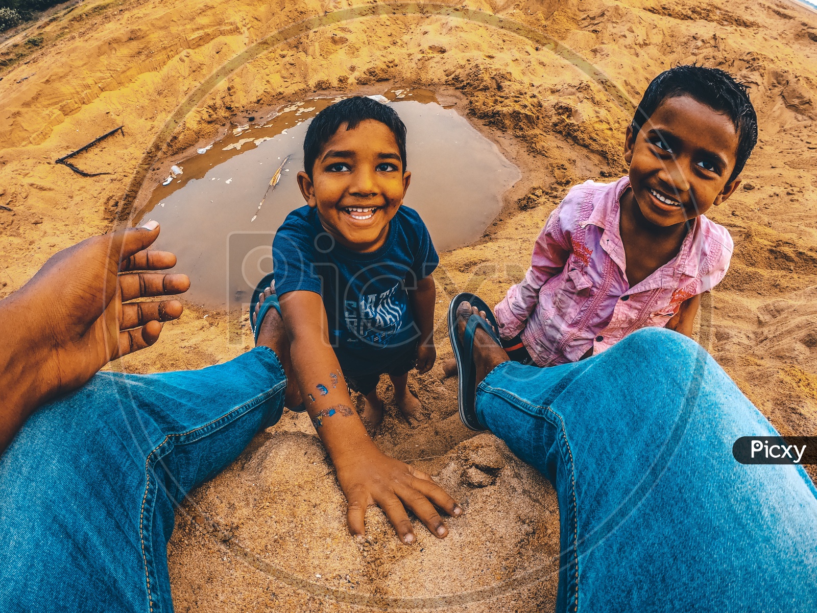 Indian rural kids smiling after playing in the sand