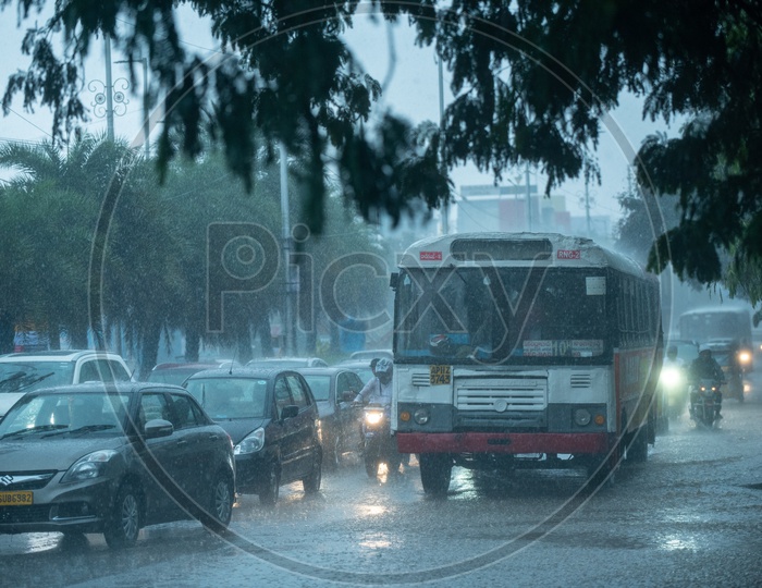 TSRTC City Bus in Traffic On a Rainy Day Near Hi-Tech City