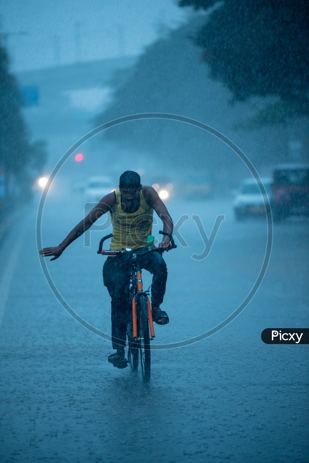 A Bicycle Rider Commuting In Heavy Rain