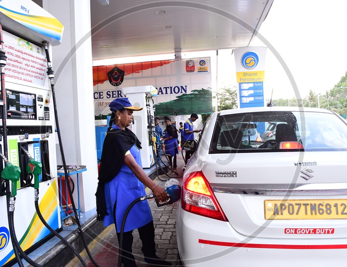 Indian Woman Filling Fuel Or Petrol at a Fuel Station Or Petrol Pump