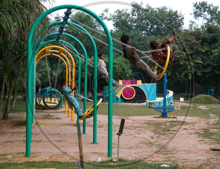Indian Children playing With Swing In a Public Park