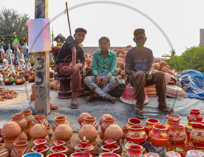 Indian Young Boys Selling Earthen Pots  At a Road Side Vendor Stall