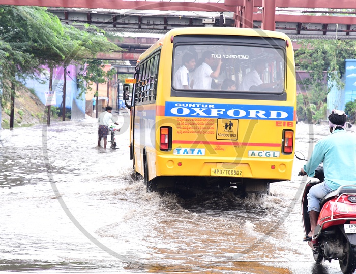 School Bus On a Flooded Road Due to Heavy Rain in Guntur City